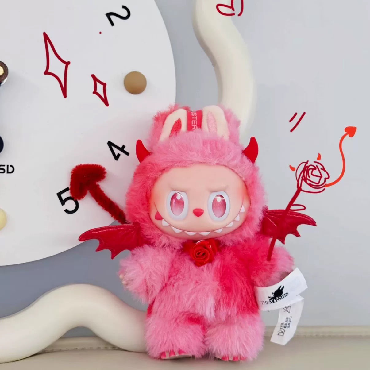 Monster Closet Labubu plush outfit with red devil horns and tail against a neutral background